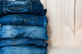 Fashionable clothes. pile of jeans on a wooden background Royalty Free Stock Photo