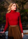 Fashionable clothes. Woman walk in autumn park. Cozy knitwear. Knitted sweater. Girl gorgeous blonde. Femininity and