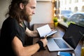 Man with long hair skilled copywriter having learning via netbook device