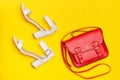 Fashionable concept. Red handbag and white shoes. Yellow background, top view Royalty Free Stock Photo