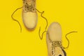 Fashionable concept. Yellow men`s work boots from natural nubuck leather on bright yellow background top view flat lay with copy Royalty Free Stock Photo