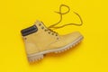 Fashionable concept. Yellow men`s work boots from natural nubuck leather on bright yellow background top view flat lay with copy Royalty Free Stock Photo