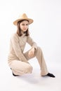 Fashionable confident teen girl wearing trendy beige sweatshirt posing on white background. Royalty Free Stock Photo