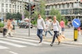 Fashionable couple crossing road at pedestrian zebra crossing Royalty Free Stock Photo