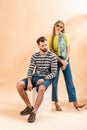 Fashionable couple posing in summer clothes on white cube Royalty Free Stock Photo