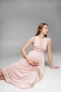 Fashionable expecting mother in pink dress Royalty Free Stock Photo