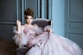 Fashionable female portrait of cute lady in pink dress indoors Royalty Free Stock Photo