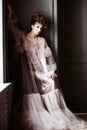 Fashionable female portrait of cute lady in pink dress indoors Royalty Free Stock Photo