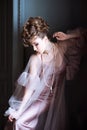 Fashionable female portrait of cute lady in pink dress indoors Royalty Free Stock Photo