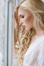 Fashionable female portrait of cute lady in white robe indoors Royalty Free Stock Photo