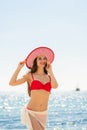 Fashionable fit young woman talking on mobile phone on the beach Royalty Free Stock Photo