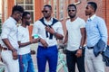 Fashionable friends at a meeting. a group of five handsome African American men well-dressed businessmen having fun and