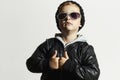 Fashionable funny child in sunglasses. Black cap.winter style.Posing Little boy.Children fashion. Kids Royalty Free Stock Photo