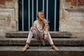 Girl sitting stairs medieval Romanesque door evening sun Royalty Free Stock Photo