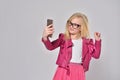 Fashionable girl child taking a selfie on smartphone Royalty Free Stock Photo