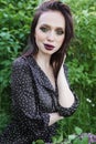 A fashionable girl with dark hair, a spring portrait in lilac tones in summer. Bright professional makeup.