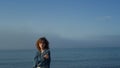 Fashionable girl looking at camera on seaside. Upset woman posing on beach Royalty Free Stock Photo