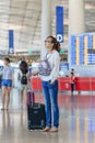 Fashionable girl looking at flight information at Beijing Capital International Airport