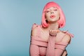 Fashionable girl in pink wig blowing air kiss with closed eyes isolated