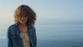 Fashionable girl posing at seashore. Smiling woman turning around on ocean beach Royalty Free Stock Photo