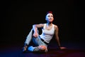 Fashionable girl with stylish haircut posing on black background with trendy