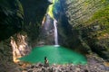 Fashionable girl in swimsuit relaxes in front of the Kozjak Waterfall, Slovenia