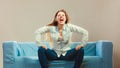 Fashionable girl wearing denim relaxing on couch. Royalty Free Stock Photo