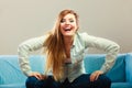 Fashionable girl wearing denim sitting on couch. Royalty Free Stock Photo