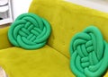 Fashionable green sofa closeup picture. stylish interior. sofa with cushions knots