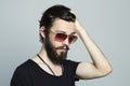 Fashionable handsome man. Brutal bearded boy in trendy sunglasses Royalty Free Stock Photo