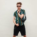 Fashionable handsome young man with sunglasses in beach shirt Royalty Free Stock Photo