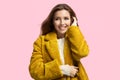 Fashionable happy girl wearing stylish yellow coat, casual attire.