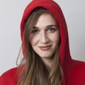 Fashionable happy 20s girl wearing a hoodie on for coolness Royalty Free Stock Photo