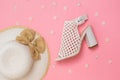Fashionable hat with bow and white braided leather Shoe on pink background with flowers. Flat lay. Royalty Free Stock Photo