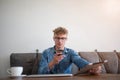 Young man modern businessman reading text message on mobile phone, holding touch pad in hand. Royalty Free Stock Photo