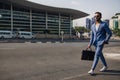 Trendy Indian businessman walking in city on daily work commute