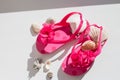 Fashionable sandals, seashells on white background, top view, flat lay.summer pink Shoes for kids, Children`s slippers Royalty Free Stock Photo