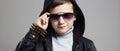 Fashionable little boy in hoodie and sunglasses Royalty Free Stock Photo