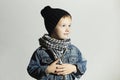 Fashionable little boy in scarf and jeans.winter style.fashion kids.funny child