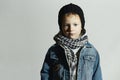 Fashionable little boy in scarf and jeans.winter style