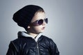 Fashionable little boy in sunglasses. Child in Black cap. Winter style.Kids fashion Royalty Free Stock Photo