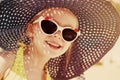 Fashionable little girl wearing a hat and sunglasses