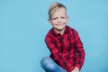 Fashionable little kid with red shirt. Fashion. Style. Studio portrait over blue background Royalty Free Stock Photo