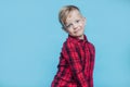 Fashionable little kid with red shirt. Fashion. Style. Studio portrait over blue background Royalty Free Stock Photo