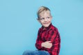 Fashionable little kid with red shirt. Fashion. Style. Studio portrait over blue background Royalty Free Stock Photo