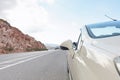 Fashionable luxury empty car with open roof is parking on road. Wonderful landscape with sky in background Royalty Free Stock Photo