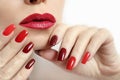 Fashionable makeup and manicure in dark red and light shades of nail Polish Royalty Free Stock Photo