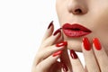 Fashionable makeup and manicure in dark red and light shades of nail Polish.