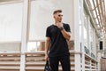 Fashionable man with hairstyle in black mockup shirt