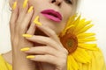 Fashionable manicure on long nails covered with yellow nail polish Royalty Free Stock Photo